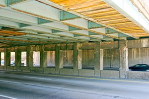 Plywood under bridges attempt to prevent pieces of the bridge from falling on vehicles.