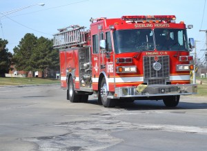 A fire truck makes an emergency run over crumbling roads in Macomb County. Vote yes for safe roads on May 5.